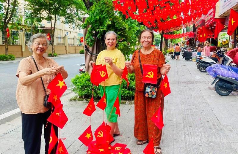 Bà Nguyễn Thị Hiền cùng những người hàng xóm trên đường Nguyễn Thái Học cùng trang trí cờ hoa.