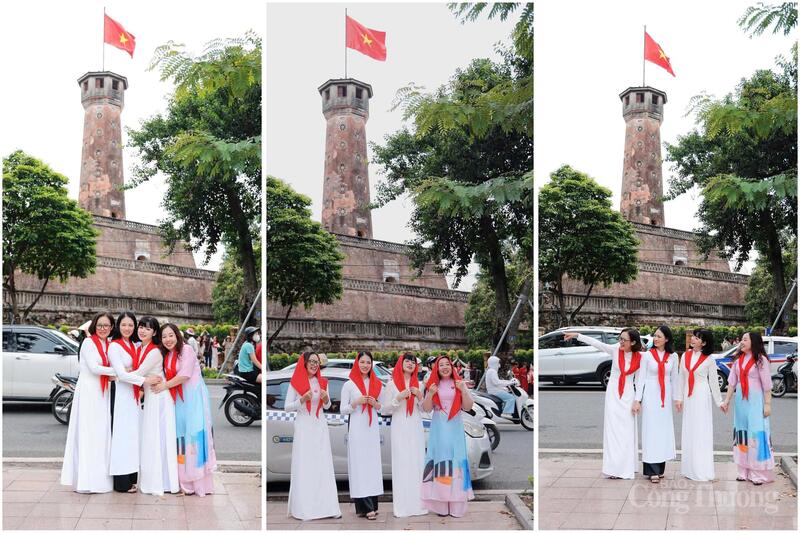 Trước Cột cờ Hà Nội, phụ nữ khoác khăn quàng đỏ chụp ảnh kỷ niệm, gợi ký ức thiếu niên và khát vọng hôm nay