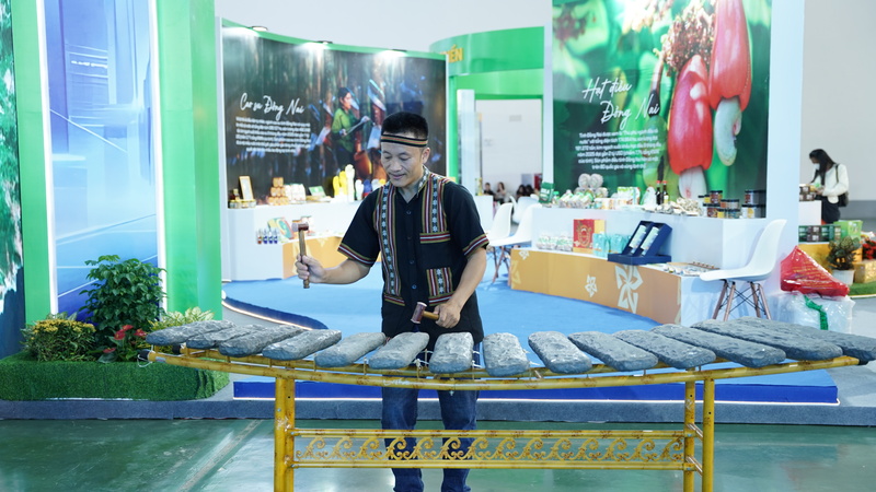 Nghệ nhân Nguyễn Duy Thảo say sưa chơi nhạc cụ tại gian hàng tỉnh Đồng Nai. Ảnh: Diệu Linh