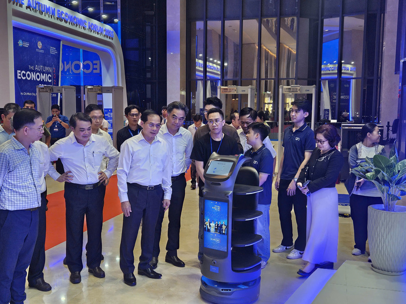 Phó Thủ tướng Bùi Thanh Sơn trao đổi với nhóm kỹ sư trẻ về khả năng vận hành, trình diễn robot AI tại diễn đàn. Ảnh: Minh Khuê.