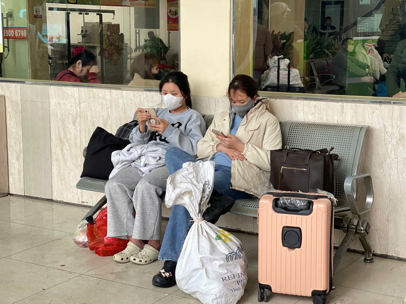 Không ít hành khách tranh thủ ngồi nghỉ bên hành lý, gương mặt vẫn còn lộ rõ sự mệt mỏi, phờ phạc sau hành trình dài. Ảnh: Mai Linh
